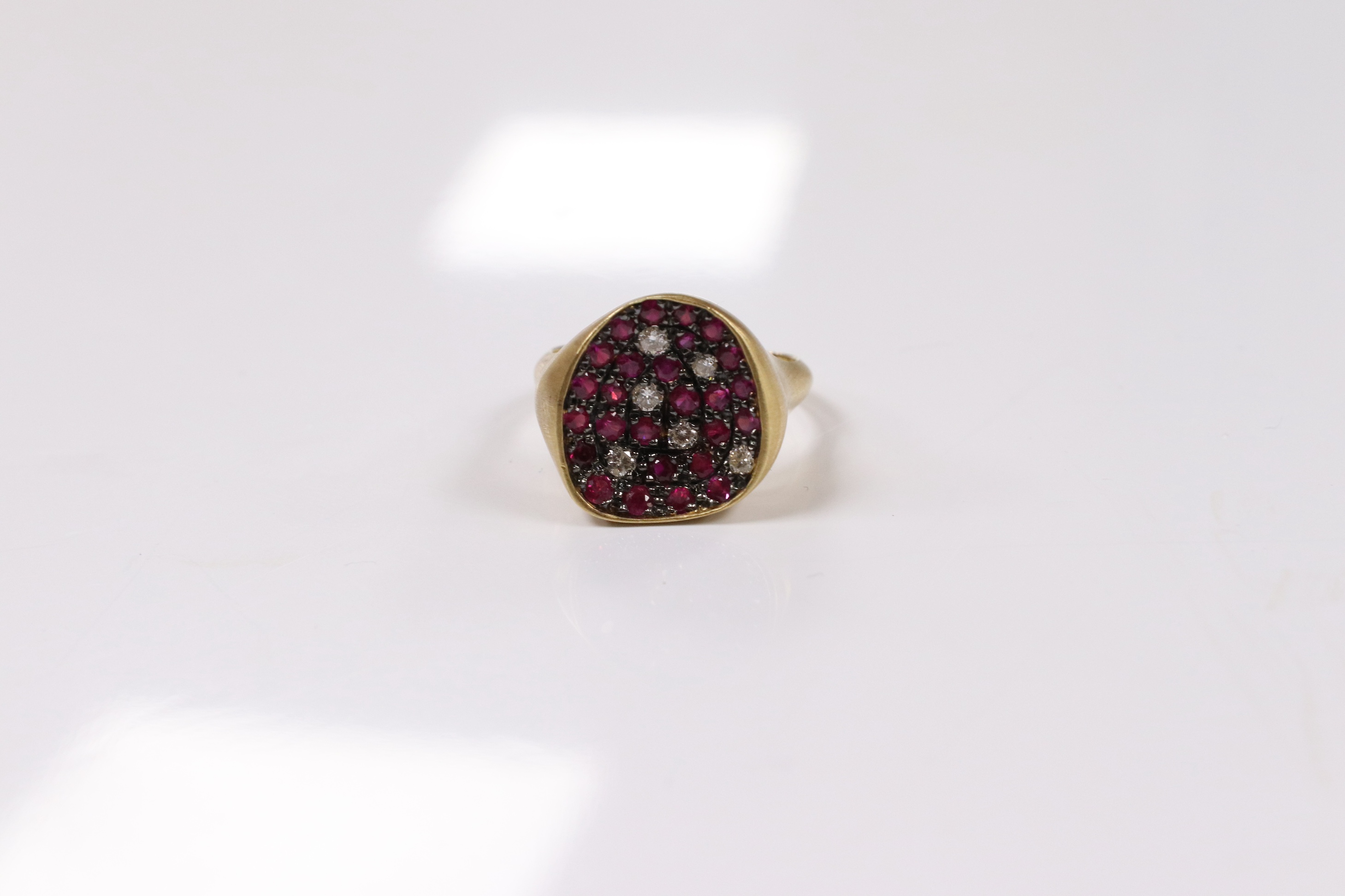 A modern 18k and pave set ruby and diamond set concave dress ring, size O, gross weight 5.4 grams. Condition - fair